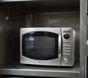 microwave on metal shelf