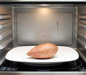 Sweet potato cooking in a microwave