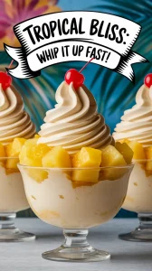 Delicious Pineapple Whip Dessert in a glass topped with cherries and fresh pineapple.